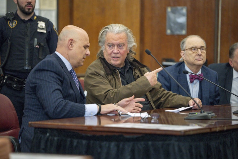 Steve Bannon speaks to his attorney in court.