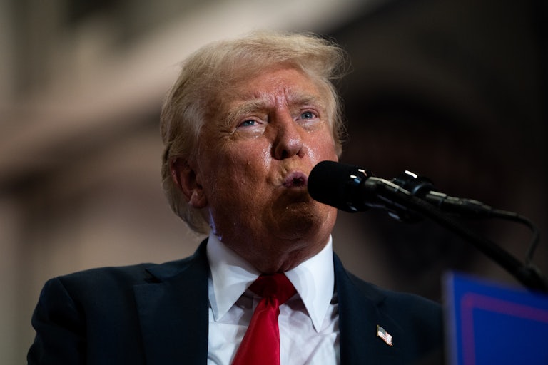 Donald Trump speaks into a mic