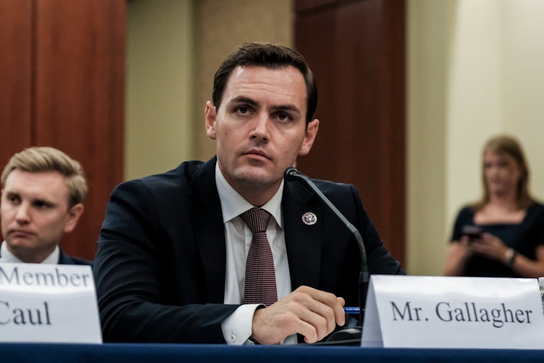 Mike Gallagher sits at a table