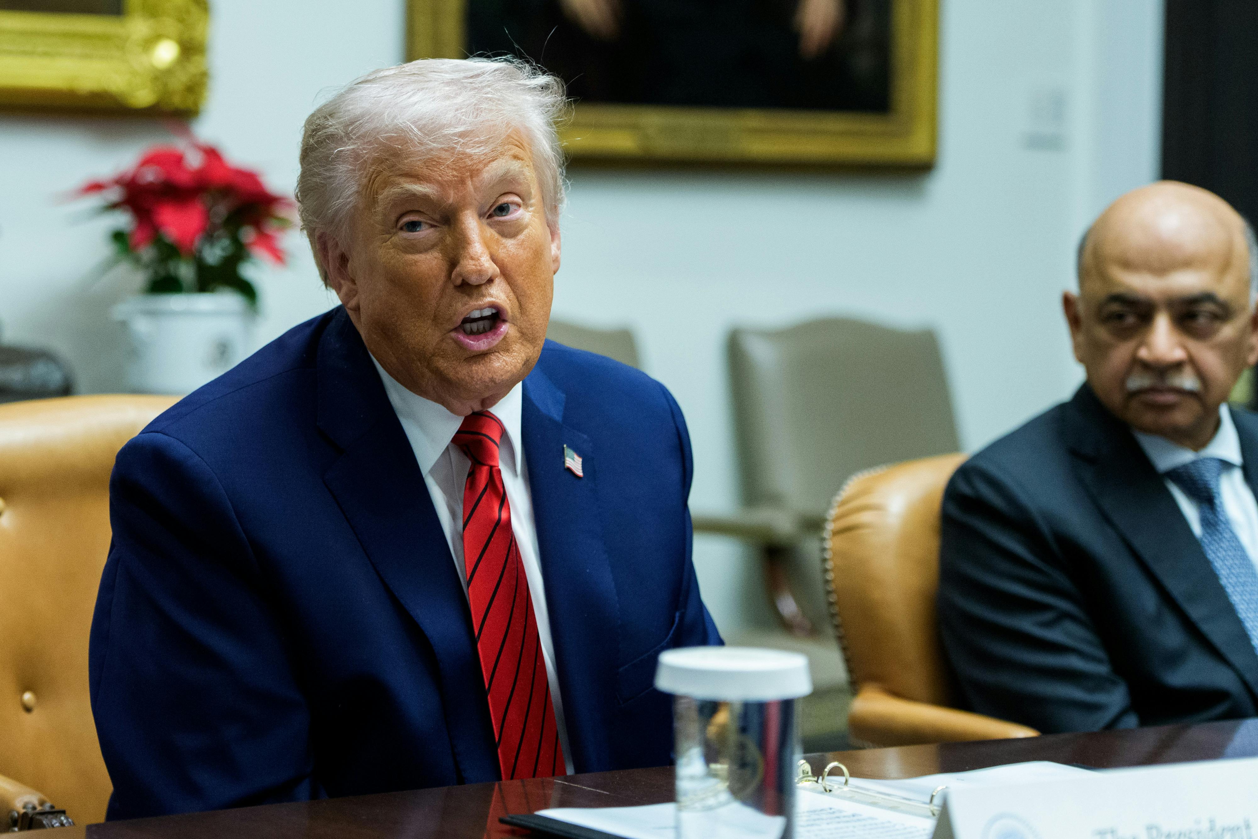President Donald Trump sitting in the Roosevelt Room in the White House during a roundtable.