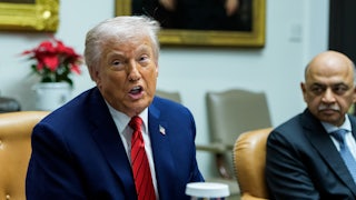 President Donald Trump sitting in the Roosevelt Room in the White House during a roundtable.