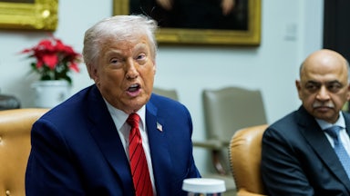 President Donald Trump sitting in the Roosevelt Room in the White House during a roundtable.