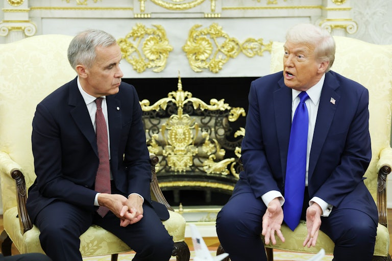 Donald Trump speaks while sitting next to Canadian Prime Minister Mark Carney in the Oval Office