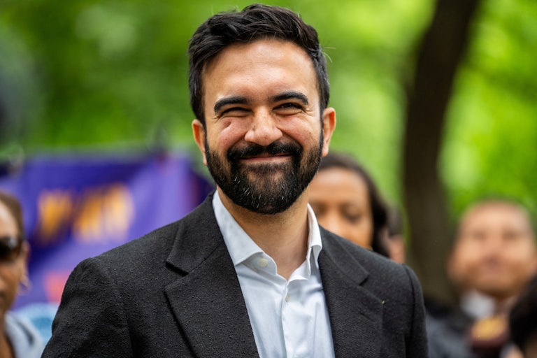 Zohran Mamdani smiles at an outdoor event