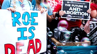 Anti-abortion protesters hold signs outside the Supreme Court shortly after Roe v. Wade was overturned.