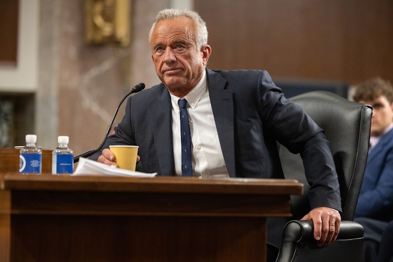 Robert F. Kennedy Jr. leans forward in his chair during his Senate confirmation hearing