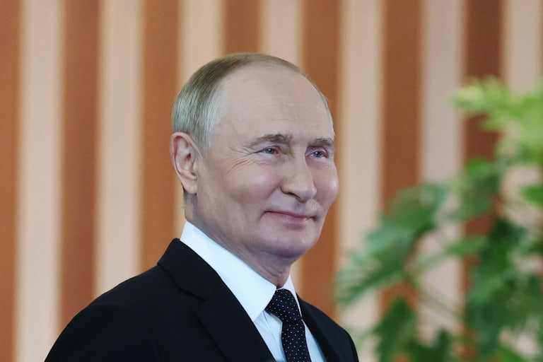 Russian President Vladimir Putin smiles