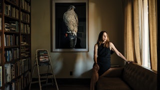 Author Rachel Kushner rests on her sofa at home.