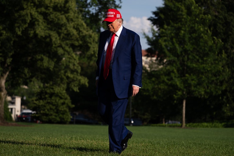 Donald Trump walks outside the White House