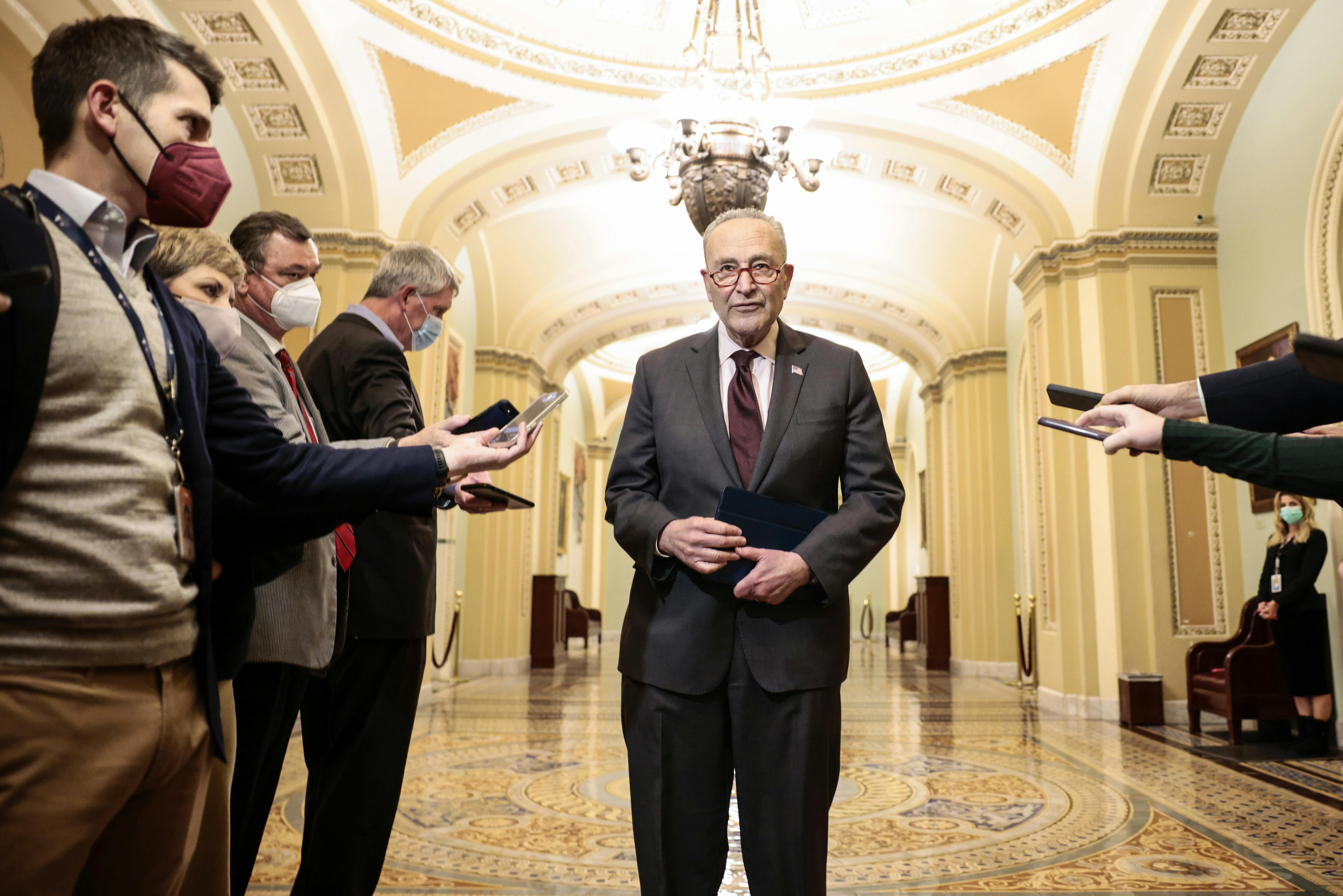  Senate Majority Leader Chuck Schumer speaks to reporters outside the Senate Chambers of the Capitol. 