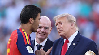 Donald Trump, standing next to FIFA President Gianni Infantino, shakes hands with Spanish player Rodri after the World Cup