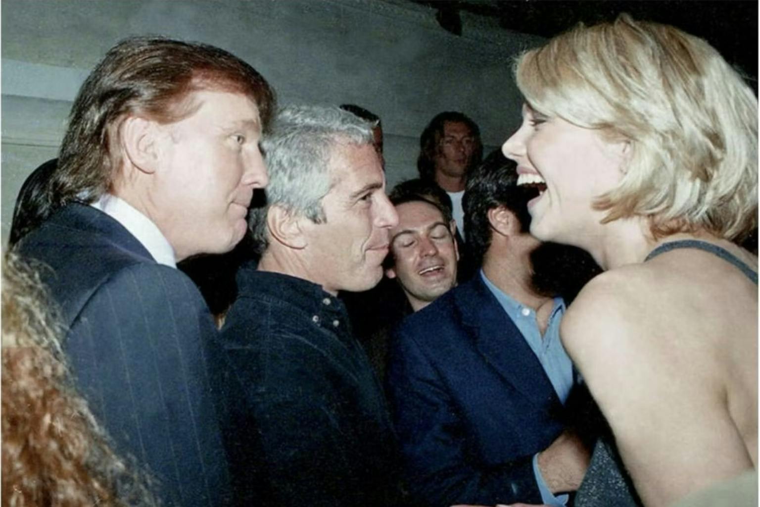 Donald Trump and Jeffrey Epstein look over at a young blonde woman who is laughing while looking back.