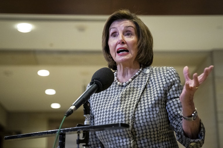 Nancy Pelosi speaks into a microphone