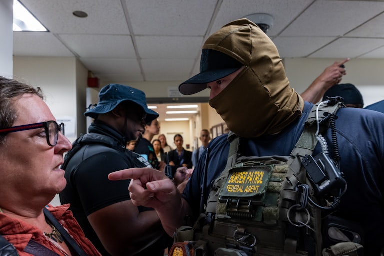 An ICE agent aggressively points at a member of the media in a Manhattan courthouse