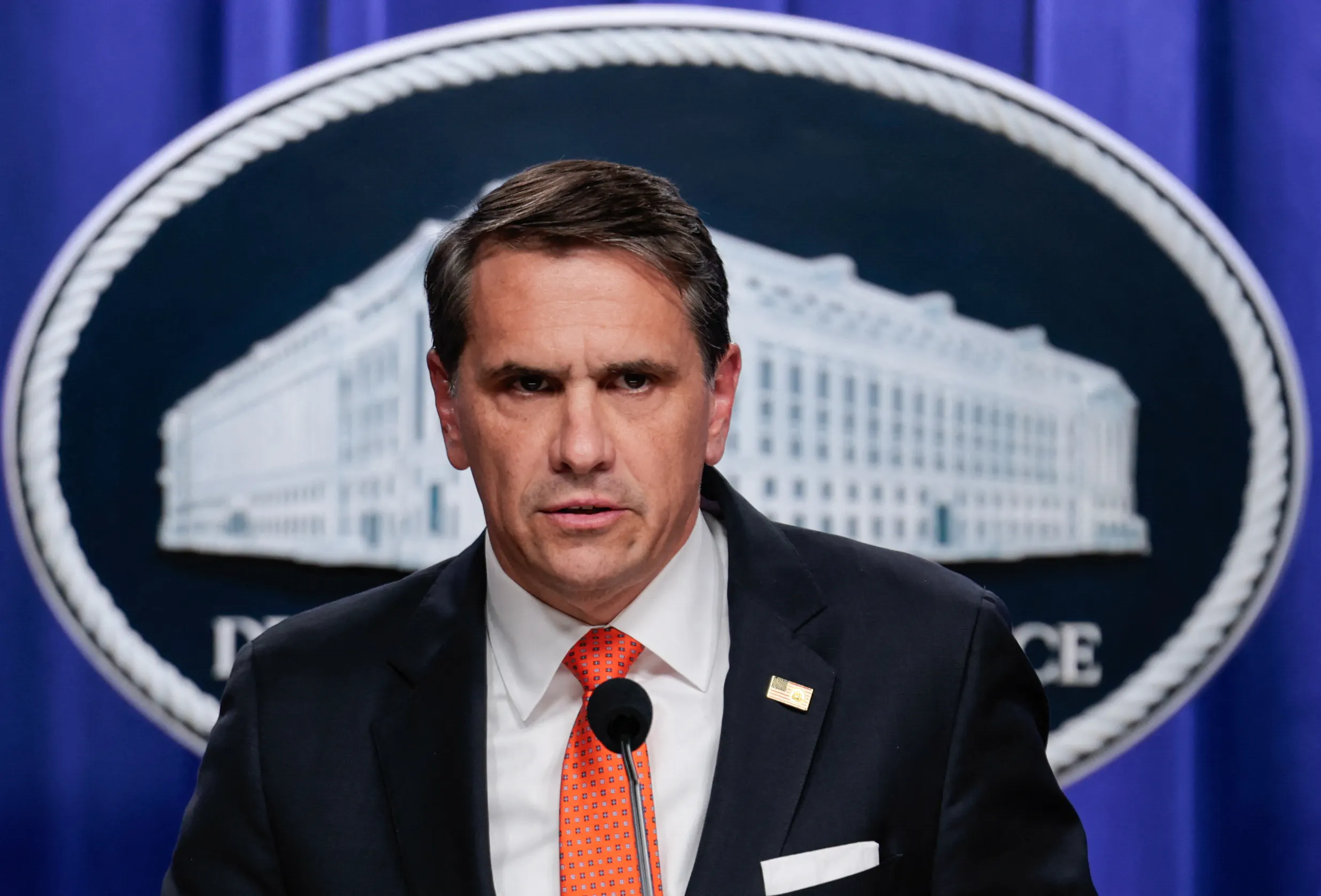 Acting Attorney General Todd Blanche frowns and speaks during a press conference