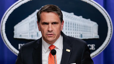 Acting Attorney General Todd Blanche frowns and speaks during a press conference