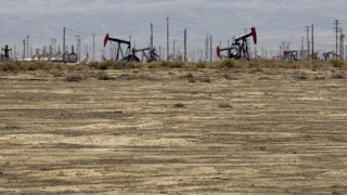 Drilling machinery stands in the California hills.