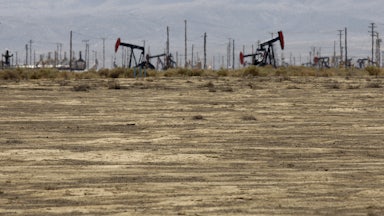 Drilling machinery stands in the California hills.