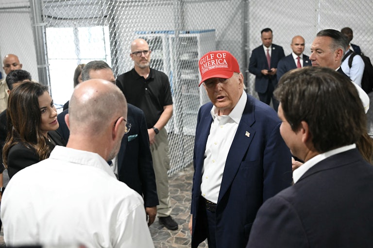 Donald Trump speaks to others inside the Alligator Alcatraz facility.