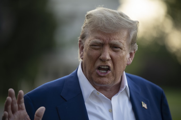 Donald Trump gestures while speaking to reporters outside the White House