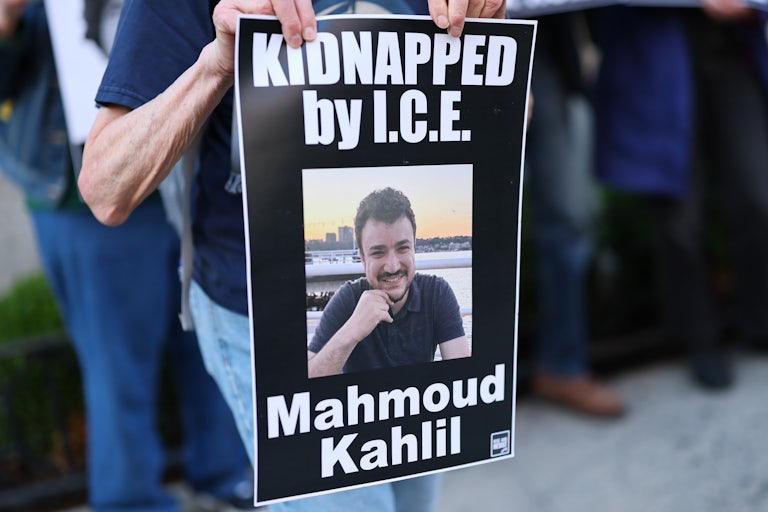 Somoene holds a sign reading "Kidnapped by I.C.E. Mahmoud Khalil," featuring a photo of Khalil smiling by the water.