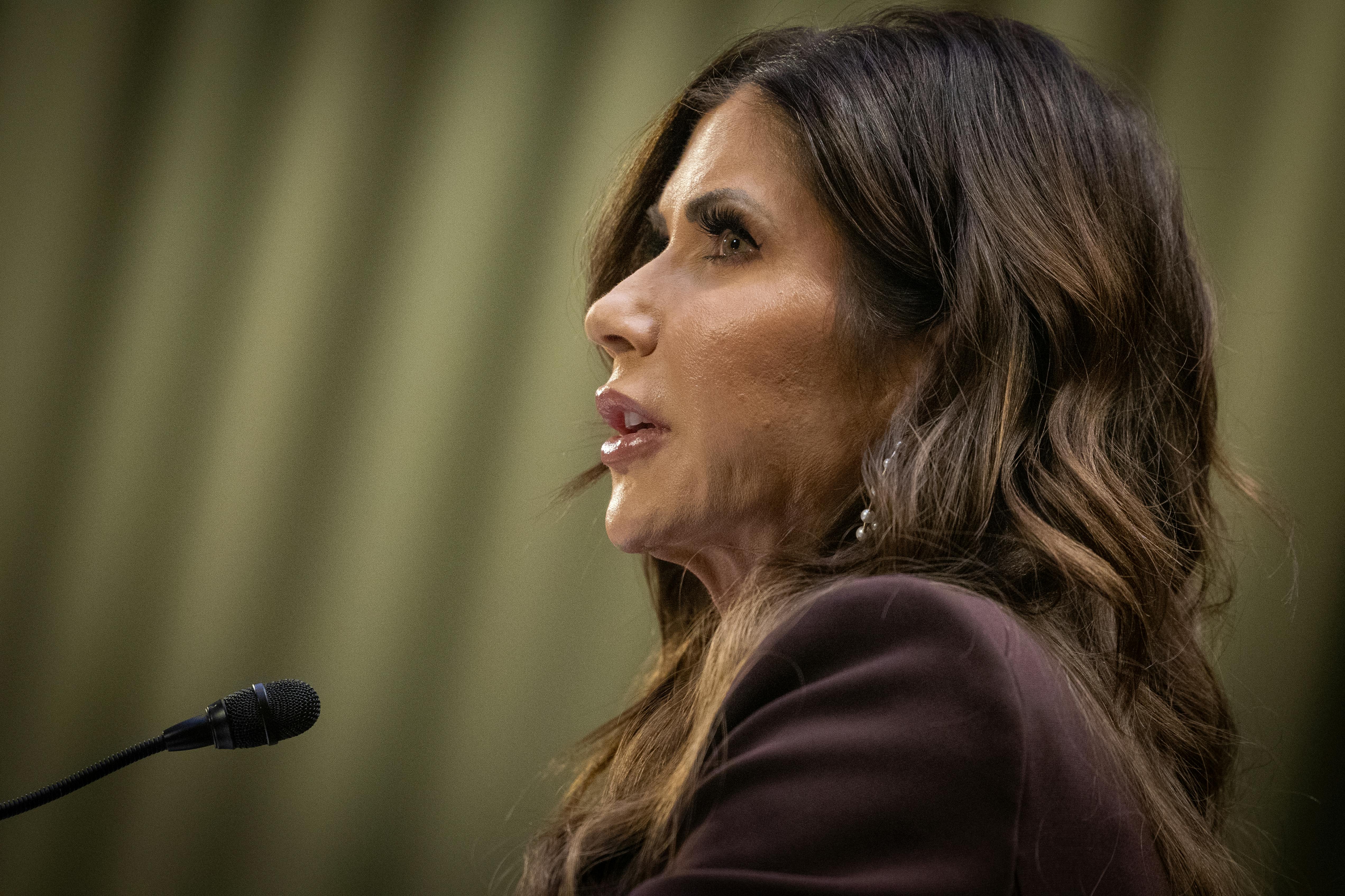 Kristi Noem speaks into a microphone during a Senate Judiciary Committee hearing