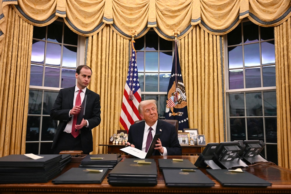 Donald Trump signs executive orders in the Oval Office of the White House in Washington, D.C.