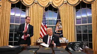 Donald Trump signs executive orders in the Oval Office of the White House in Washington, D.C.