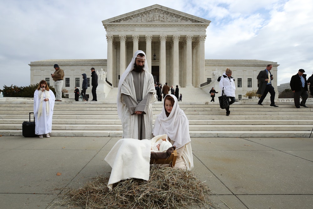 A couple portrays Mary and Joseph during a live nativity scene in front of the U.S. Supreme Court.