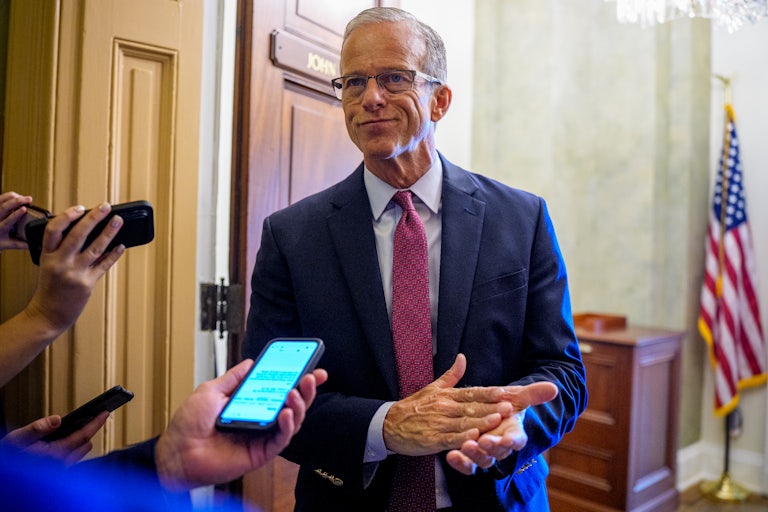 Reporters surround Senate Majority Leader John Thune in the Capitol.