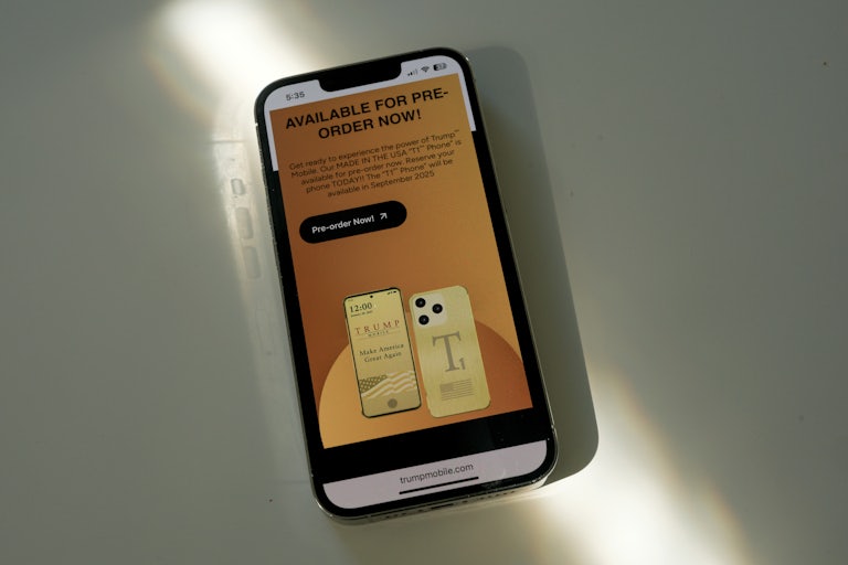 A phone screen shows the pre-order website for Trump Mobile phones