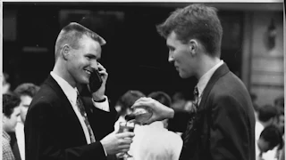 Accountants wearing expensive suits and using mobile phones at an after work drinks gathering in 1994