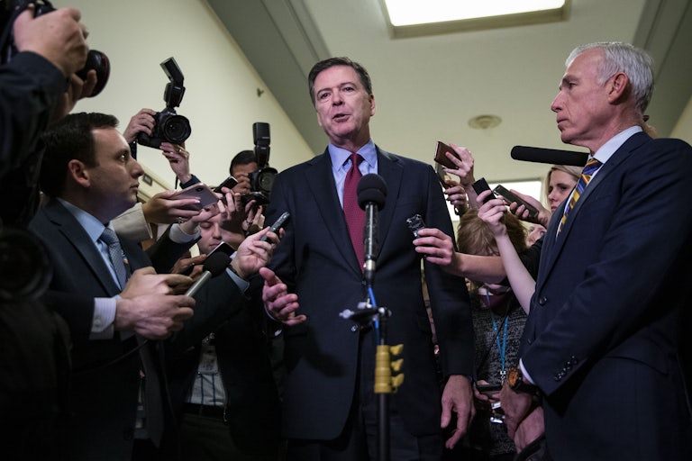 James Comey speaks to reporters in the Capitol