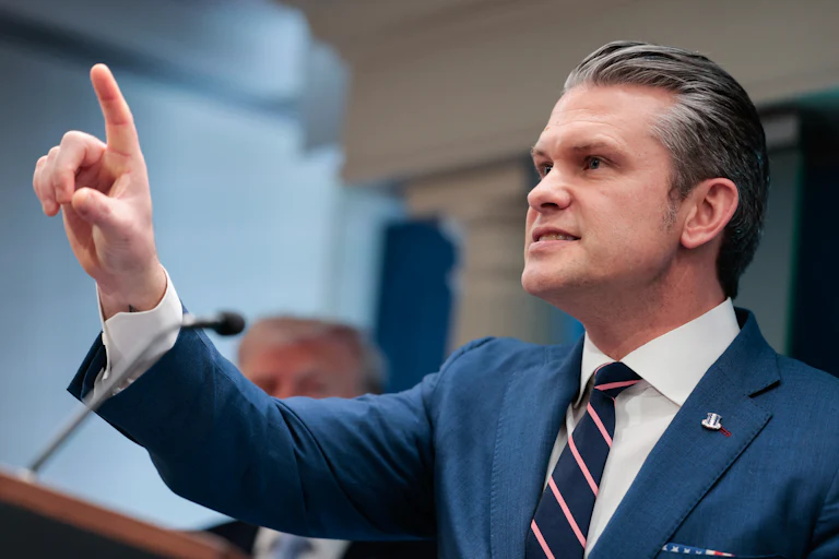 Defense Secretary Pete Hegseth points a finger