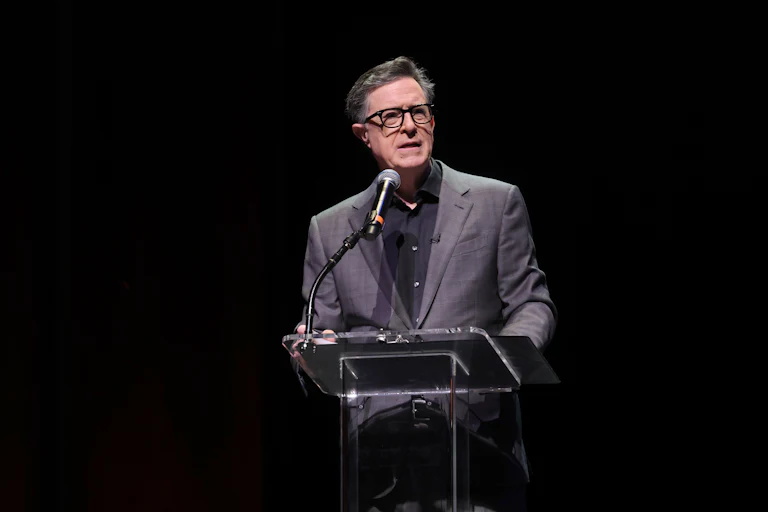 Stephen Colbert speaks at a podium