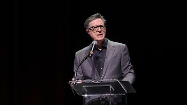 Stephen Colbert speaks at a podium