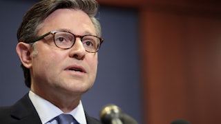 House Speaker Mike Johnson speaks into microphone