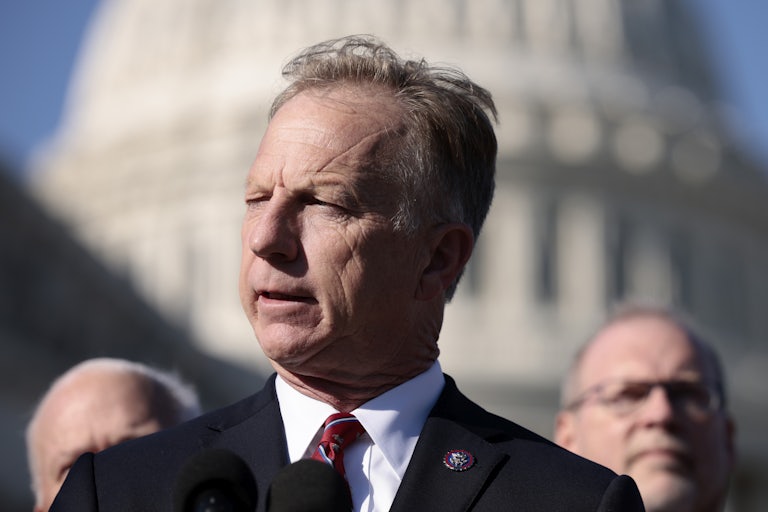 Kevin Hern holds a press conference outside the Capitol. He squints in the sunlight.