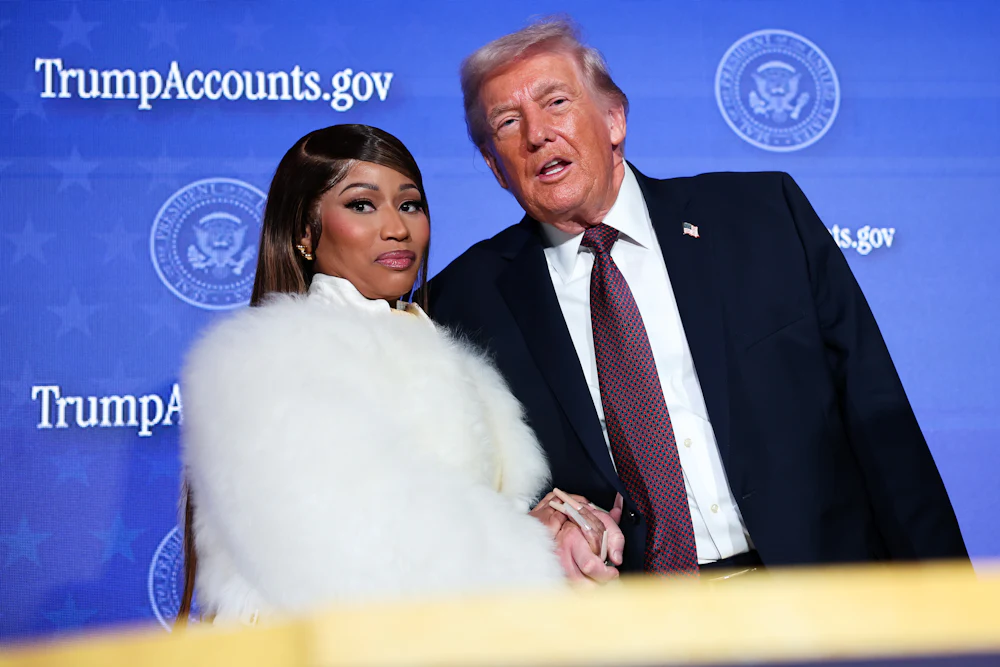 Musician Nicki Minaj joins Donald Trump on stage as he delivers remarks during the Treasury Department’s Trump Accounts Summit.
