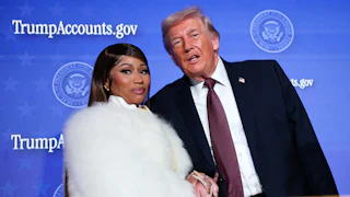 Musician Nicki Minaj joins Donald Trump on stage as he delivers remarks during the Treasury Department’s Trump Accounts Summit.