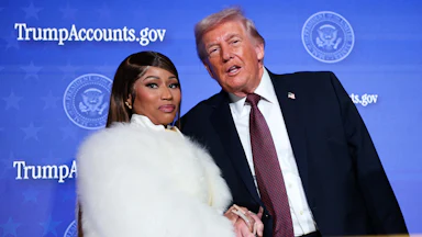 Musician Nicki Minaj joins Donald Trump on stage as he delivers remarks during the Treasury Department’s Trump Accounts Summit.