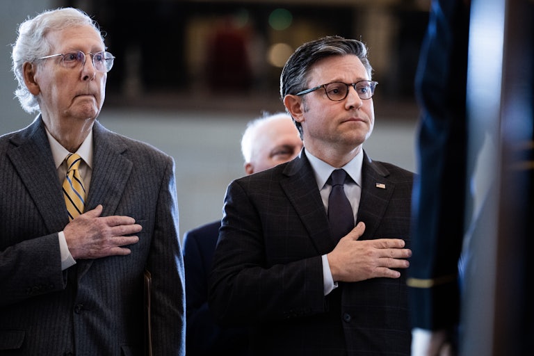 Mitch McConnell and Mike Johnson stand with their hands over their hearts