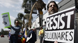 A protest outside a Tesla dealership