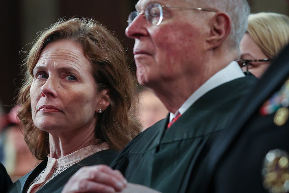 Supreme Court Justice Amy Coney Barrett and retired Supreme Court Justice Anthony Kennedy listen as President Donald Trump addresses a joint session of Congress.