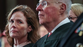 Supreme Court Justice Amy Coney Barrett and retired Supreme Court Justice Anthony Kennedy listen as President Donald Trump addresses a joint session of Congress.