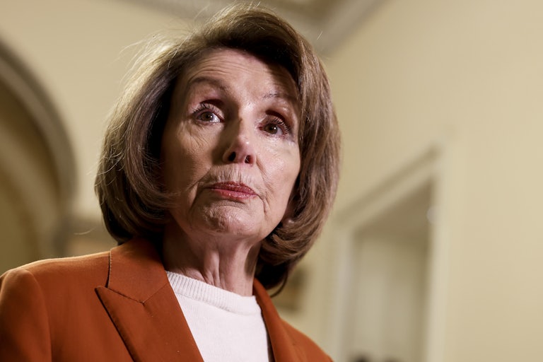 Nancy Pelosi raises her eyebrows and purses her lips