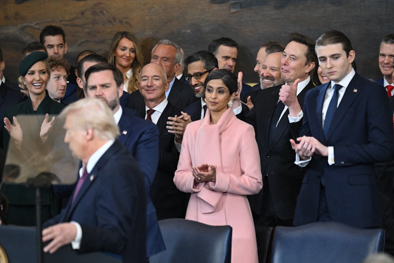 CEOs Jeff Bezos, Sundar Pichai, and Elon Musk stand behind Donald Trump as he speaks at his inauguration