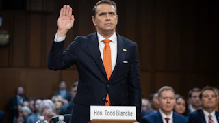 Acting Attorney General Todd Blanche raises his hand while standing in his Senate committee confirmation hearing