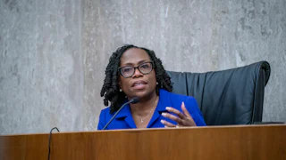 Supreme Court Justice Ketanji Brown Jackson speaks at a dais