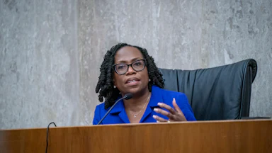 Supreme Court Justice Ketanji Brown Jackson speaks at a dais